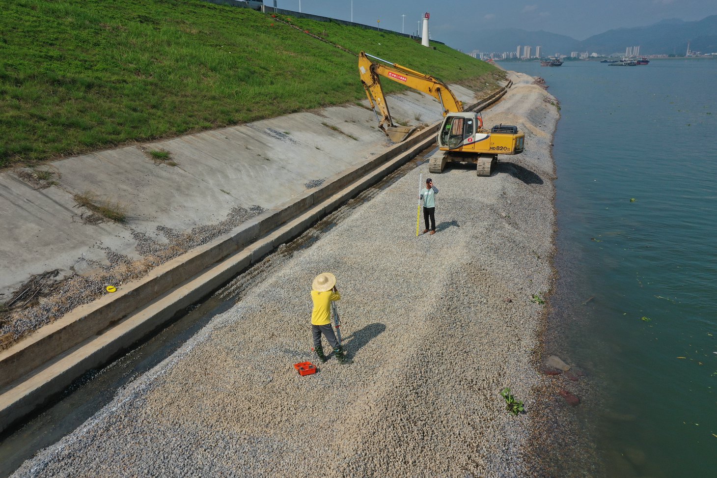 Survey crew measuring coastal installation
