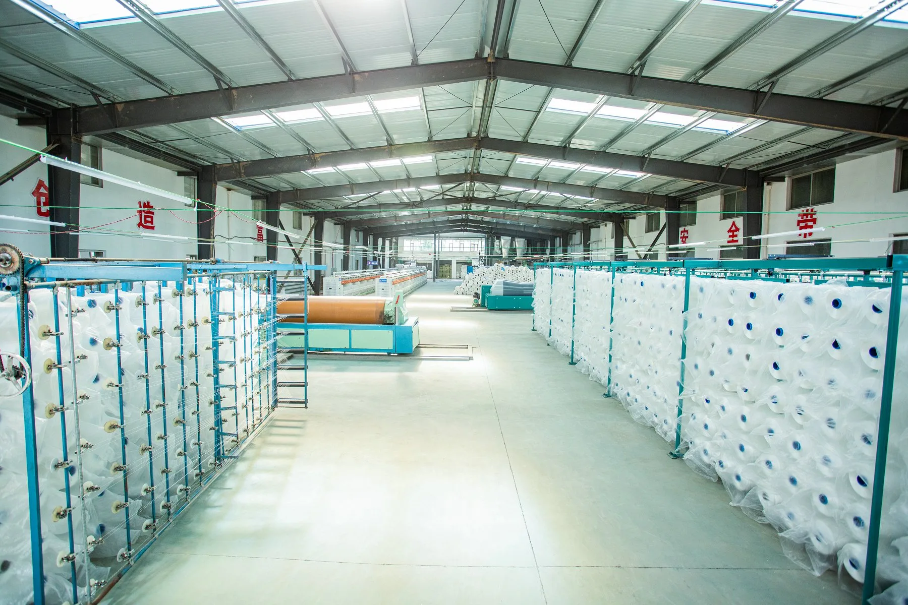 Factory production of geotextile fabric for fabric formed concrete mattress systems