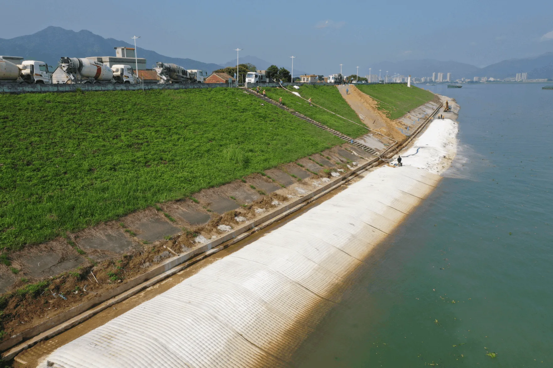 Coastal seawall slope installation with mixer trucks
