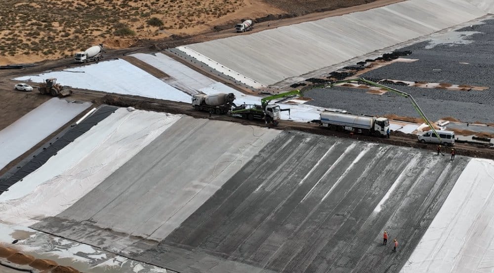 Aerial view of grouted mattress installation at remote desert mining water management pond