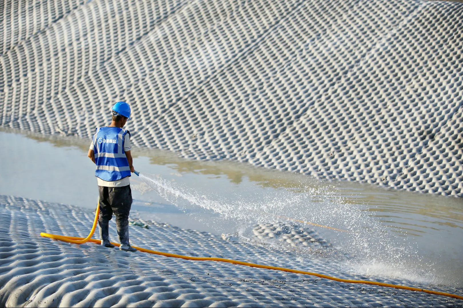 Worker curing grouted mattress surface
