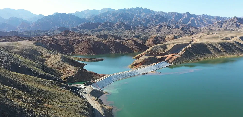 Aerial view of mountain reservoir with grouted mattress upstream face lining on embankment dam
